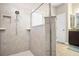 A luxurious shower with a glass enclosure, tile surround, and recessed niche in this well-appointed bathroom at 4407 Scarlet Loop, Wesley Chapel, FL 33544