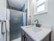 Modern bathroom with a glass-enclosed shower, vanity, and sink at 451 27Th N Ave, St Petersburg, FL 33704