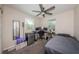 Bedroom with two windows, carpeted floor, ceiling fan, and mirror with a bed and desk at 451 27Th N Ave, St Petersburg, FL 33704