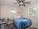 Bedroom with blue bedding, two windows, ceiling fan, gray carpet, and desk at 451 27Th N Ave, St Petersburg, FL 33704