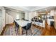 Open concept dining area with a long wooden table and black chairs, with kitchen bar seating in the background at 451 27Th N Ave, St Petersburg, FL 33704