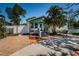 Exterior home showcasing mature palm trees, brick driveway, and manicured landscape at 451 27Th N Ave, St Petersburg, FL 33704