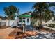 Charming single-Gathering home featuring a cozy front porch, mature trees, and meticulous landscaping at 451 27Th N Ave, St Petersburg, FL 33704