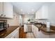 Open concept kitchen features stainless steel appliances, modern lighting, and white cabinets at 451 27Th N Ave, St Petersburg, FL 33704