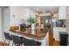The open concept kitchen features barstool seating and stainless steel appliances, and opens to the dining area at 451 27Th N Ave, St Petersburg, FL 33704