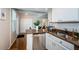 Bright kitchen area with stainless steel dishwasher and sink, granite countertops, and modern lighting at 451 27Th N Ave, St Petersburg, FL 33704