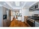 Bright kitchen features stainless steel appliances, hardwood floors, and white cabinetry at 451 27Th N Ave, St Petersburg, FL 33704