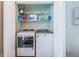 Convenient laundry closet features a white washer and dryer, and wire shelving for optimal storage at 451 27Th N Ave, St Petersburg, FL 33704