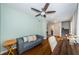Office with dark desk, hardwood floors, and a gray sofa, offering a comfortable workspace at 451 27Th N Ave, St Petersburg, FL 33704