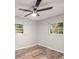 Well-lit bedroom with wood floors, light-colored walls, and two windows for natural light at 4516 W Paxton Ave, Tampa, FL 33611