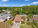 An aerial view shows the property's proximity to a lake and surrounding lush greenery and neighborhood at 4519 Swallowtail Dr, New Port Richey, FL 34653