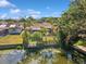 Aerial view of the property with a dock and pond at 4519 Swallowtail Dr, New Port Richey, FL 34653