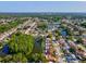 Aerial view of the home in a residential neighborhood with a lake at 4519 Swallowtail Dr, New Port Richey, FL 34653