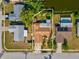 Aerial view of a single-Gathering home featuring a backyard pool, tropical landscaping, and canal access at 4519 Swallowtail Dr, New Port Richey, FL 34653