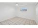 Simple bedroom with tile floor, a window for natural light, and a ceiling fan at 4519 Swallowtail Dr, New Port Richey, FL 34653