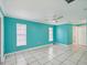 Bedroom with tile floors, bright walls, and a modern ceiling fan for comfort at 4519 Swallowtail Dr, New Port Richey, FL 34653
