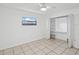 Bedroom featuring tile flooring, natural light, and an open closet space at 4519 Swallowtail Dr, New Port Richey, FL 34653