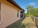 Home exterior featuring stucco walls, a screened porch, and a well-maintained lawn by a water view at 4519 Swallowtail Dr, New Port Richey, FL 34653