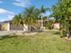 Charming single-story home showcasing lush landscaping, a well-manicured lawn, and a two-car garage at 4519 Swallowtail Dr, New Port Richey, FL 34653