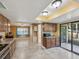Open kitchen layout with modern appliances, wood cabinets, and access to the outdoor patio area at 4519 Swallowtail Dr, New Port Richey, FL 34653