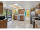 Well-lit kitchen featuring stainless steel appliances, stone countertops, and seamless access to outdoor patio at 4519 Swallowtail Dr, New Port Richey, FL 34653