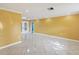 An airy, large living room is enhanced by its tile flooring, ceiling fan, and french doors at 4519 Swallowtail Dr, New Port Richey, FL 34653