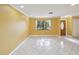 The spacious living room features large windows, tile flooring, and a decorative front door at 4519 Swallowtail Dr, New Port Richey, FL 34653