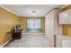 Home office features a built-in desk, storage cabinets, and natural light from the window at 4519 Swallowtail Dr, New Port Richey, FL 34653