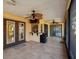 Enclosed patio with tile flooring, ceiling fans, a bar, and access to the screened-in porch at 4519 Swallowtail Dr, New Port Richey, FL 34653