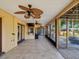 Enclosed patio boasts tile flooring, ceiling fans, a bar, and a screened-in porch for outdoor enjoyment at 4519 Swallowtail Dr, New Port Richey, FL 34653