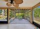 Inviting screened-in porch with seating, wood flooring, and views of the serene backyard at 4519 Swallowtail Dr, New Port Richey, FL 34653