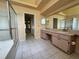Bright bathroom features tiled floors, a large mirror, and a glass-enclosed shower at 4593 Goldcoast Ave, Spring Hill, FL 34609