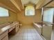Well-lit bathroom featuring tile flooring, an enclosed shower, a large bathtub and a wide vanity at 4593 Goldcoast Ave, Spring Hill, FL 34609