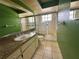 The bathroom has a granite countertop, green walls and a glass enclosed shower at 4593 Goldcoast Ave, Spring Hill, FL 34609