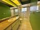 The bathroom has a granite countertop, green walls and a glass enclosed shower at 4593 Goldcoast Ave, Spring Hill, FL 34609