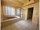 Spacious bathroom features tile flooring, enclosed shower, tub, and vanity at 4593 Goldcoast Ave, Spring Hill, FL 34609