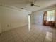 A bedroom with tiled floors and a neutral color scheme has two closets at 4593 Goldcoast Ave, Spring Hill, FL 34609
