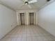 The bedroom features tiled floors, a window and closets for storage at 4593 Goldcoast Ave, Spring Hill, FL 34609