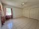 The bedroom features tiled floors, a window and double closets for storage at 4593 Goldcoast Ave, Spring Hill, FL 34609
