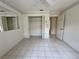 Bright bedroom featuring tiled floors and a large closet with open doors at 4593 Goldcoast Ave, Spring Hill, FL 34609