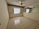 This secondary room features tile floor, a ceiling fan and large windows at 4593 Goldcoast Ave, Spring Hill, FL 34609