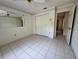 Bright bedroom featuring tiled floors, large closet, and decorative wallpaper border at 4593 Goldcoast Ave, Spring Hill, FL 34609