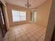 Dining room featuring tile flooring, modern light fixture, and view to the backyard at 4593 Goldcoast Ave, Spring Hill, FL 34609