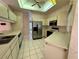 Well-lit kitchen with stainless steel appliances, tile flooring, and light wood cabinets at 4593 Goldcoast Ave, Spring Hill, FL 34609