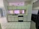 Bright eat-in kitchen with white cabinets, stainless steel appliances, and tile floors at 4593 Goldcoast Ave, Spring Hill, FL 34609