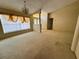 Open living space with neutral carpet, columned entrance, and large windows, perfect for relaxing or entertaining at 4593 Goldcoast Ave, Spring Hill, FL 34609
