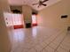 Open living room boasts tile flooring, fireplace, and bright windows with decorative plants at 4593 Goldcoast Ave, Spring Hill, FL 34609