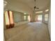 Large living room with a ceiling fan, sliding glass doors and a mirrored wall at 4593 Goldcoast Ave, Spring Hill, FL 34609