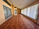 Large enclosed sunroom with tile flooring and multiple sliding glass door entrances at 4593 Goldcoast Ave, Spring Hill, FL 34609