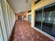 Enclosed sunroom with tile flooring, vertical blinds, and ceiling fan at 4593 Goldcoast Ave, Spring Hill, FL 34609